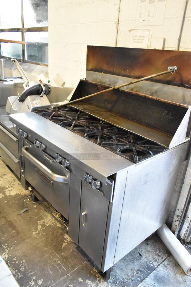 Southbend stainless steel 8 burner commercial range with oven on casters, used condition, features robust controls and sturdy design.