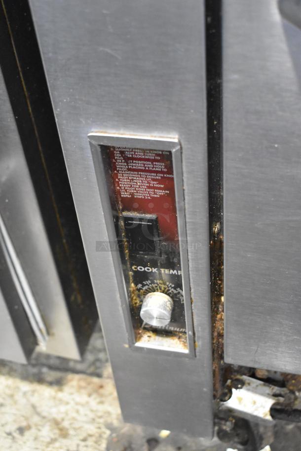 Southbend stainless steel 8 burner range with oven on commercial casters. Visible cook temperature dial and minor wear.