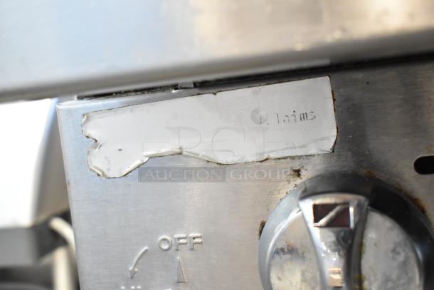Southbend stainless steel 8 burner range control panel, showing temperature dial and partially worn label.