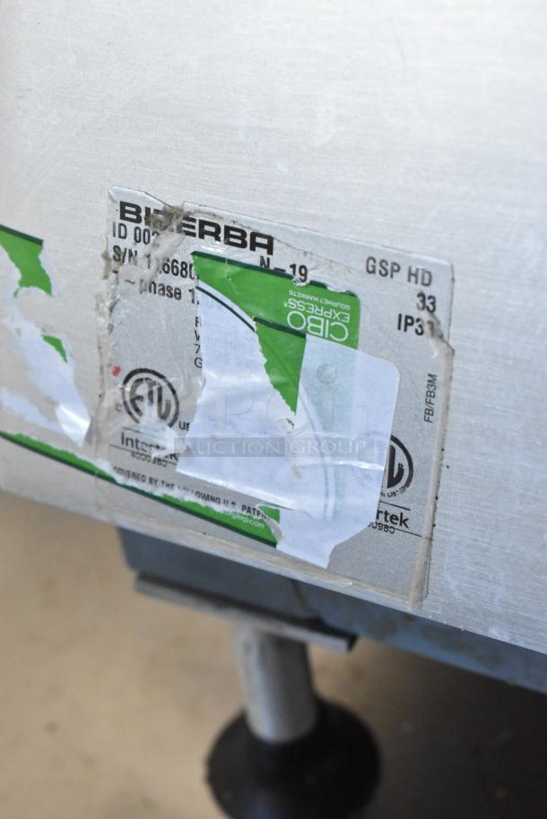 Bizerba GSP HD metal commercial meat slicer with a label showing model and electrical specifications. Visible wear on the label.