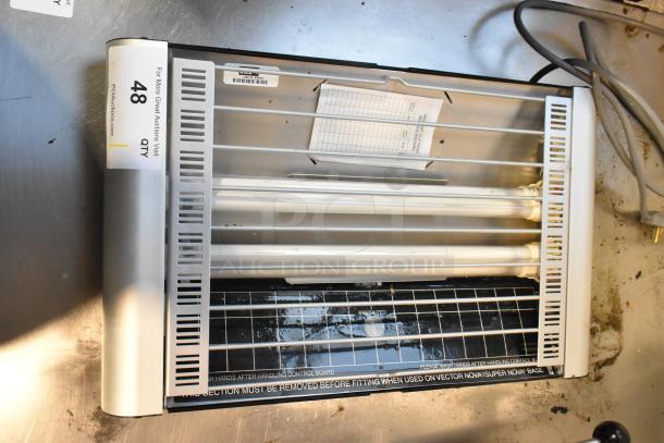 Metal bug zapper, 120 volts, 1 phase, shown unplugged. Features visible light tubes and protective grid. Item condition appears used.