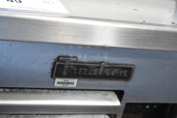 Traulsen stainless steel 2-drawer chef base on commercial casters, 115 volts, 1 phase. Some surface wear visible.