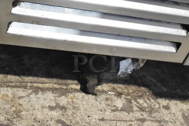 Traulsen stainless steel 2-drawer chef base on commercial casters, 115 volts, 1 phase. Some visible wear on caster.