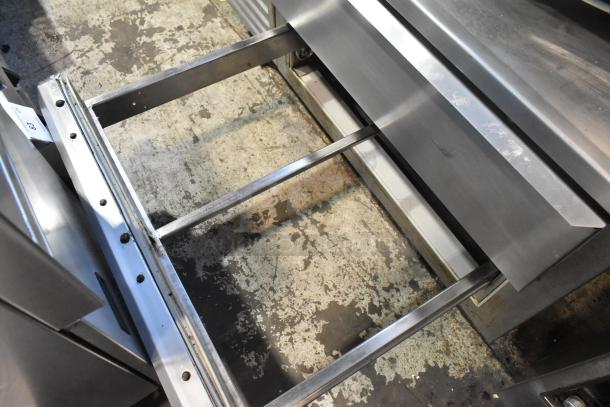 Traulsen stainless steel commercial 2-drawer chef base on casters, 115 volts, 1 phase, open base view, in used condition.