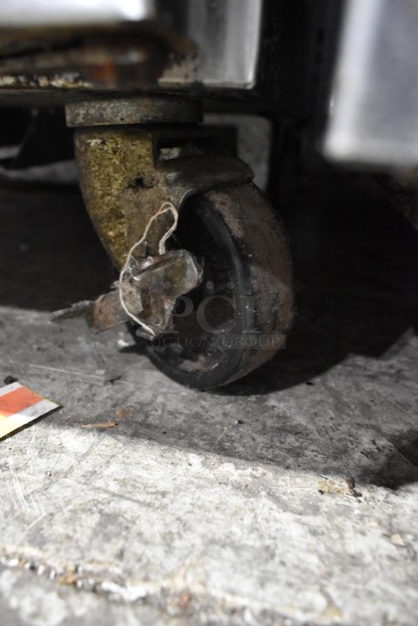 Continental Stainless Steel Kegerator caster wheel with visible rust and wear, part of a commercial unit.