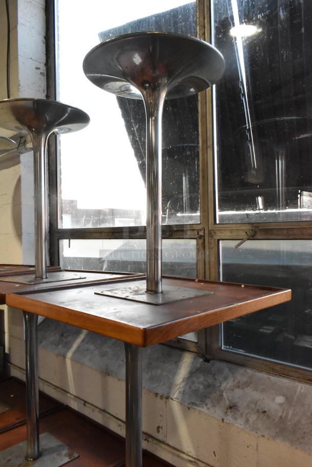 Dining height table with chrome finish base, wooden top. Multiple units available. Unique design enhances dining spaces.