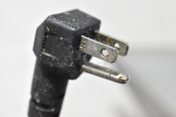 A close-up of a power plug for a Continental SW48N18M commercial sandwich salad prep table, showcasing the plug's prongs and connector.