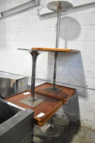 Set of five dining-height tables with chrome metal bases, wooden tops. Visible minor wear. Auction tags labeled "35" attached.