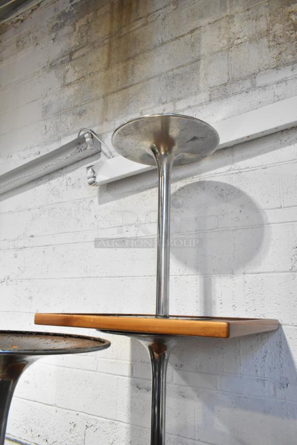 5 dining height tables with chrome metal bases, showcasing a sleek, modern design. Good condition with wooden tops.