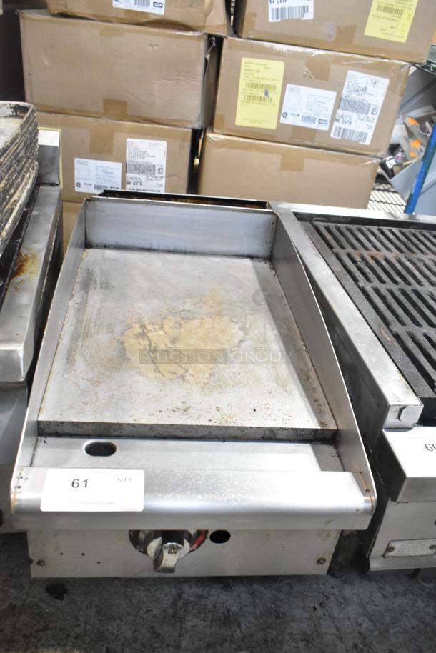 Stainless steel commercial countertop gas griddle, flat top, used condition, visible control knob, slight surface wear.