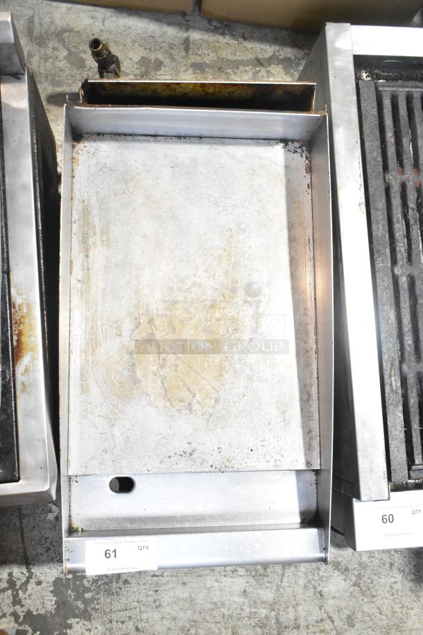 Stainless steel commercial countertop gas-powered flat top griddle with visible wear and signs of use. Auction tag "61 QTY".