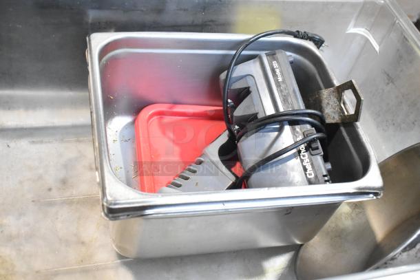 Lot of assorted items including metal baking pans and bowls, Chef'sChoice Model 320 sharpener, and a red lid.