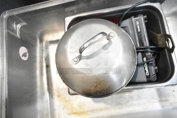 Lot of various kitchen items including metal baking pans, metal bowls, and a Chef's Choice Model 320. Visible wear.