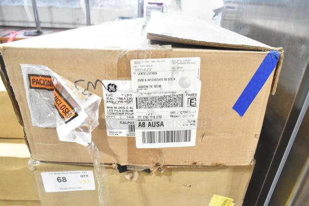 Six new boxes containing General Electric GE H5SM Light and Dual Lite LED Emergency Light, sealed packaging visible.