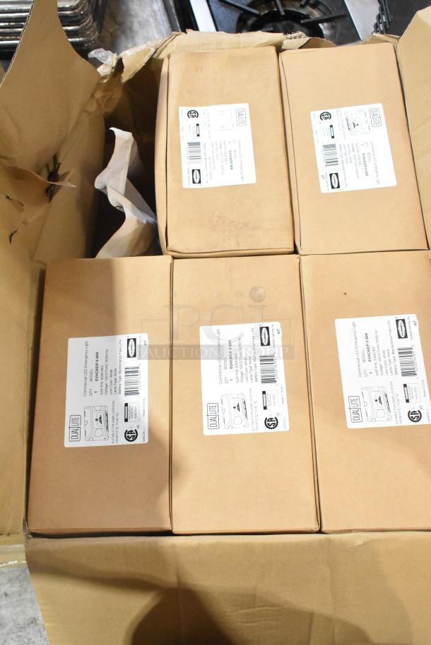 Six brand new boxes containing General Electric GE H5SM lights and Dual Lite LED emergency lights, as labeled.