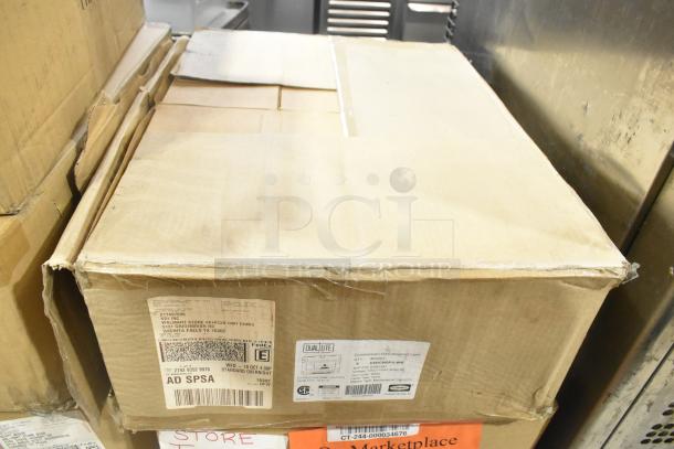 Six new boxes containing General Electric GE H5SM lights and Dual Lite LED emergency lights. Boxes show address labels.