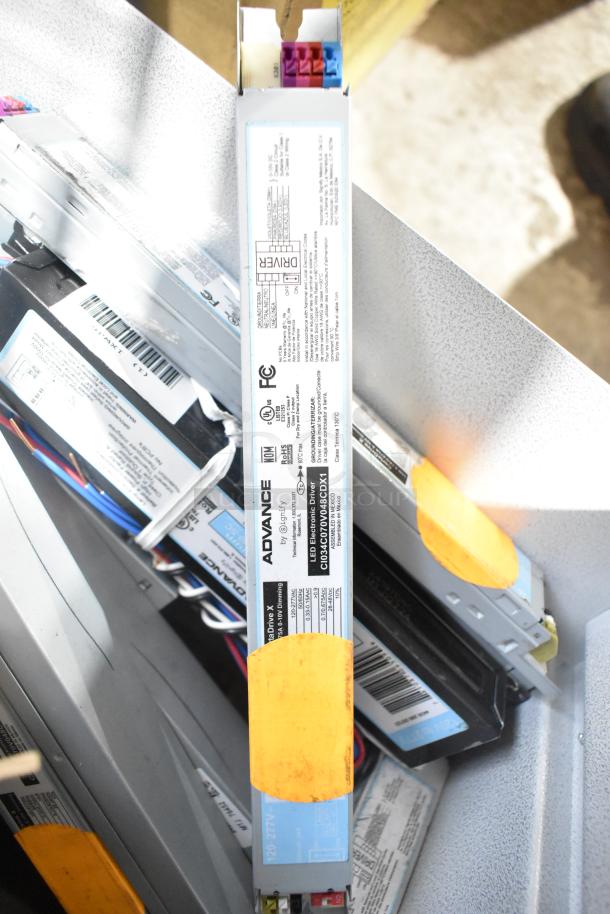 Lot of various ballasts, including Advance brand. Labels show product details and electrical specifications. Mixed condition.