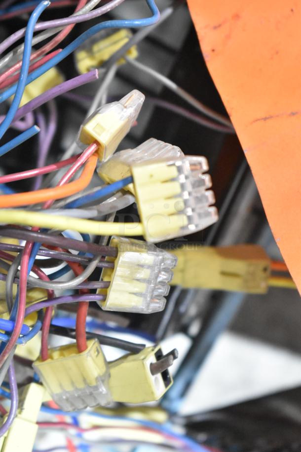 Lot of various ballasts with multiple colorful wires and connectors. Used condition, suitable for electrical projects.