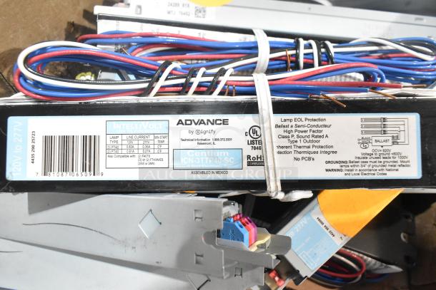 Lot of various electronic ballasts, including Advance Centium ICN-3TPI40-SC, for 120-277V, with mixed wiring and labels.