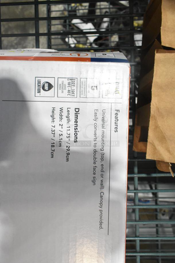 Brand new Lithonia Lighting exit sign packaging with features: universal mounting, double-face conversion, dimensions 11.75"x2"x7.37".