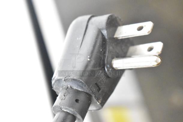 Close-up of a black three-prong plug from the 2018 Scotsman HID312A-1A ice machine, showing electrical connection detail.