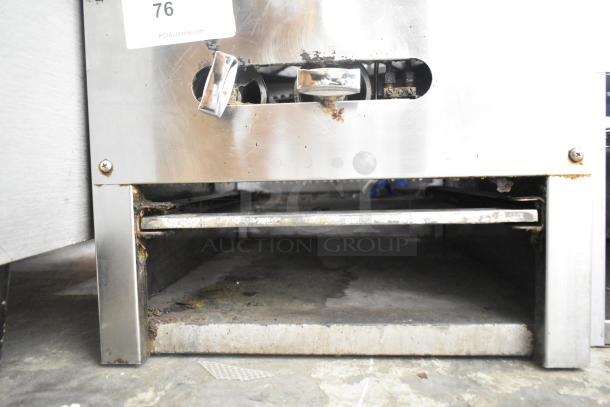 Stainless steel commercial gas-powered single burner stock pot range, used condition, visible corrosion, auction tag.