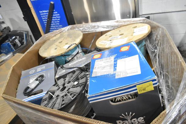 Pallet lot with spools of wire, wrapped in plastic, including Paige wire boxes and various items. Condition: new/unused.