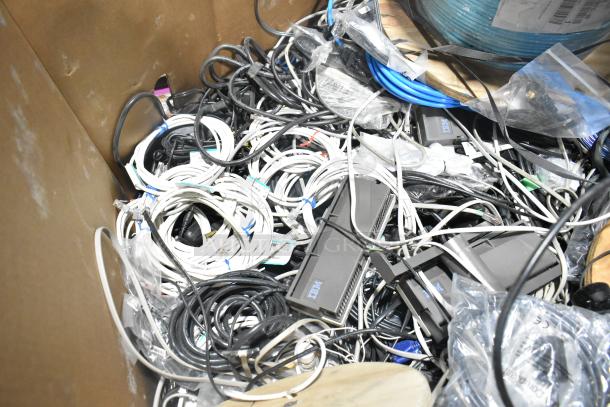 Pallet lot containing spools of wire, assorted cables, and electronic components. Visible tags indicate model and length details.