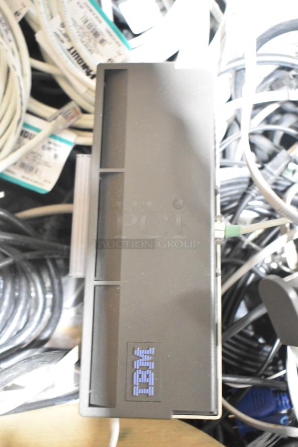 Pallet lot with various items, prominently featuring spools of wire and an IBM-branded component, in used condition.