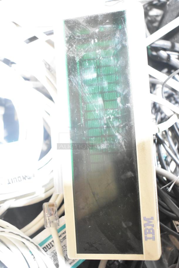 Pallet lot of various items including spools of wire, mixed electronic components, and an IBM device in used condition.