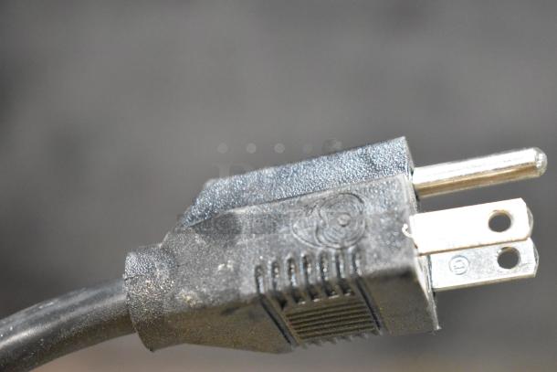 Close-up of a power plug for a Hero S2700 Mega-Mix 5 Gallon Vibrational Shaker. Black plastic with visible prongs.