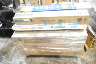 Stack of new lighting items including Philips Fluorescent, GE T8 LED, and Sylvania tube lights, boxed and shrink-wrapped.