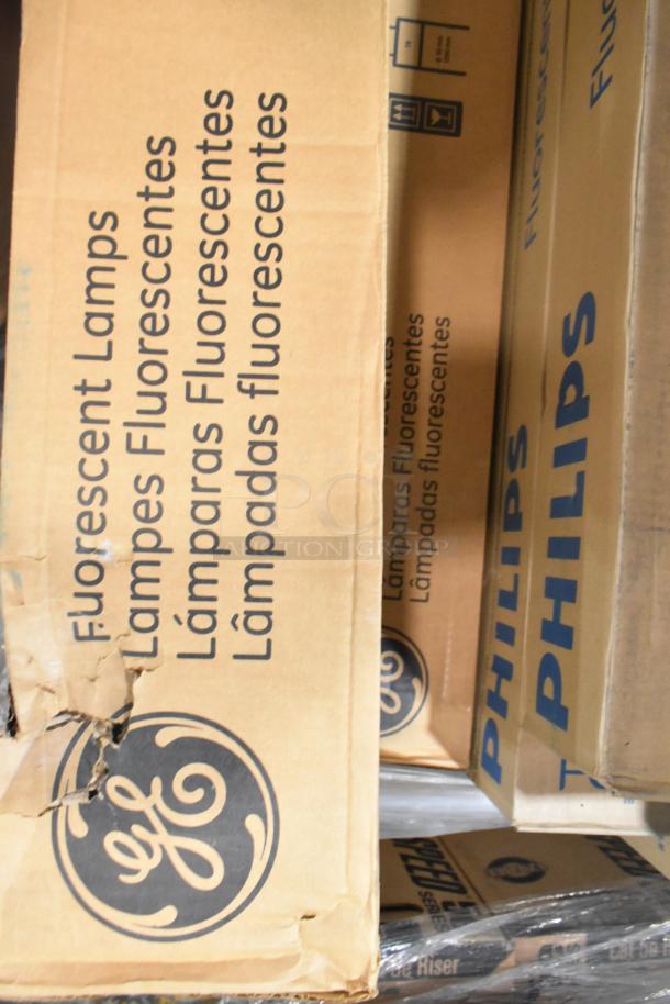 Boxes of Philips Fluorescent, GE T8 LED Daylight, and Sylvania tube lights, new condition, visible brand logos.