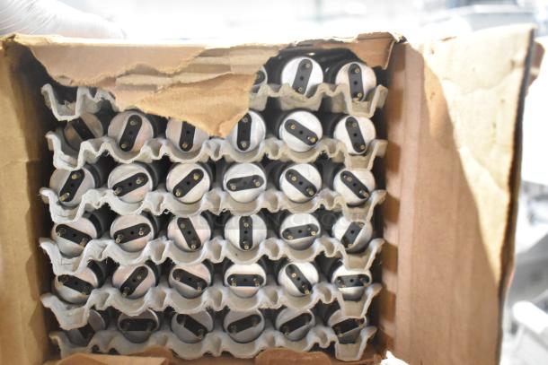 Box of 25 new fluorescent and LED tube lights by Philips, GE, and Sylvania. Ends visible in packaging.