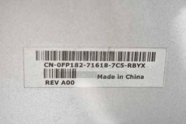 Barcode label showing "CN-0FP182-71618-7C5-RBYX," "Made in China," and "REV A00" on the computer monitor.