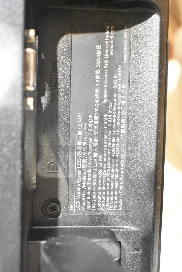 Close-up of a Dell monitor label, model E173Sc, detailing input rating, energy consumption, and manufacturing information.