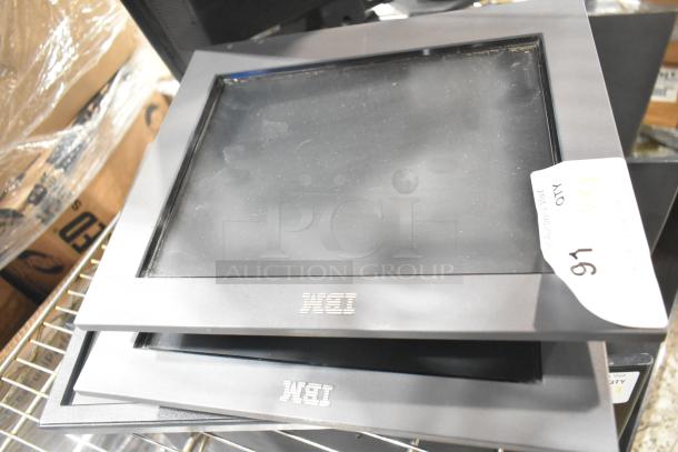 5 stacked computer monitors, including Dell, with WEI logo. Auction tag indicates quantity as 5. Monitors show signs of wear.