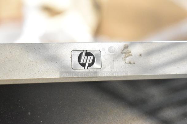 Three computer monitors, including Dell and HP. One HP monitor shown with logo. Monitors in used condition.