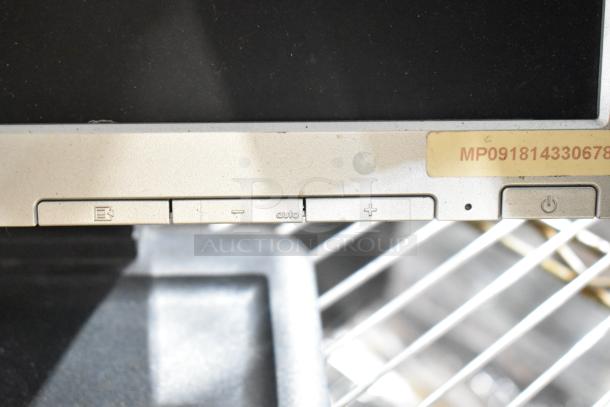 Three computer monitors including Dell and HP, with control buttons. Label reads "MP091814330678." Auction item in fair condition.