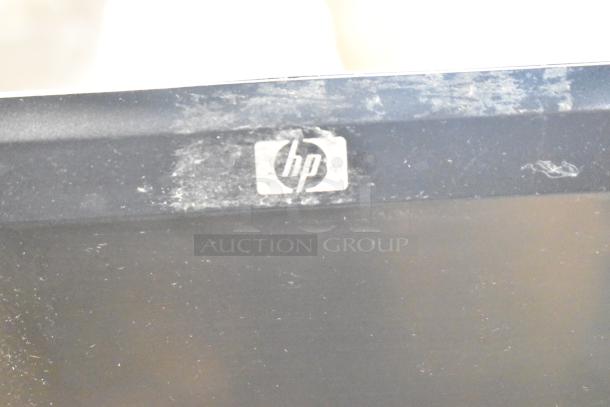 HP computer monitor with visible logo, slight surface wear. Part of a lot with two additional monitors including Dell.