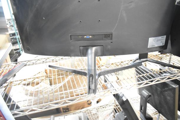 Four computer monitors including Samsung C32R500FHN and LG, various sizes, HDMI and VGA ports, visible wear, auction lot.