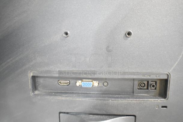 Back panel of a monitor, showing HDMI, VGA, and power inputs. Dust visible, indicating used condition.