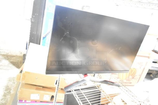 Four computer monitors, including Samsung C32R500FHN and LG model. Visible signs of use with minor scratches.