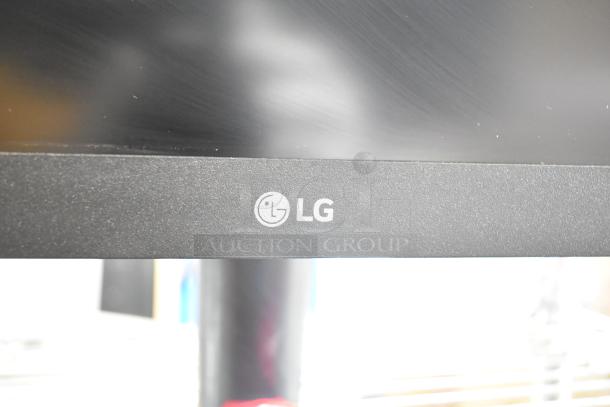 4 computer monitors including Samsung C32R500FHN and LG. Visible LG logo on a matte black bezel.