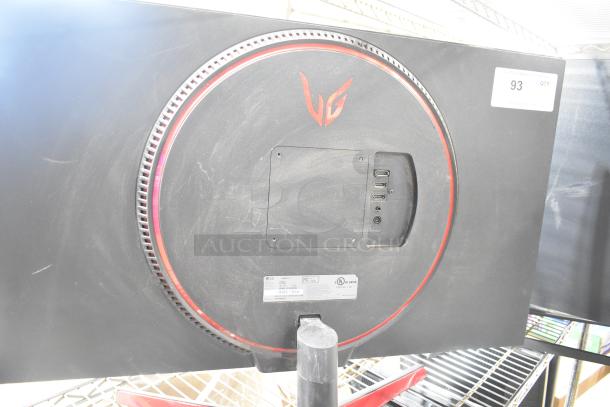 Four computer monitors, including Samsung C32R500FHN and LG, with VESA mounts and input ports, mild surface dust visible.