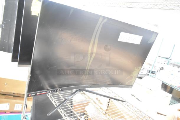 Four computer monitors including Samsung C32R500FHN and LG. Used condition, visible wear. Includes labels, "Used Asset."