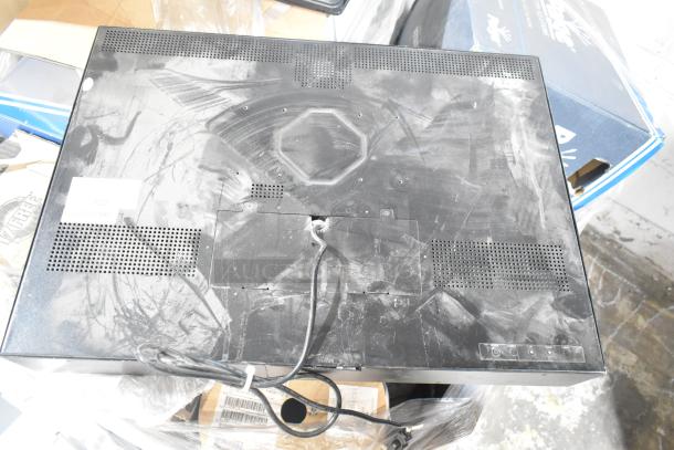 Dusty 26" TFT LCD monitor rear view with visible cables and ventilation grills. Signs of wear. Auction lot includes 15 items.