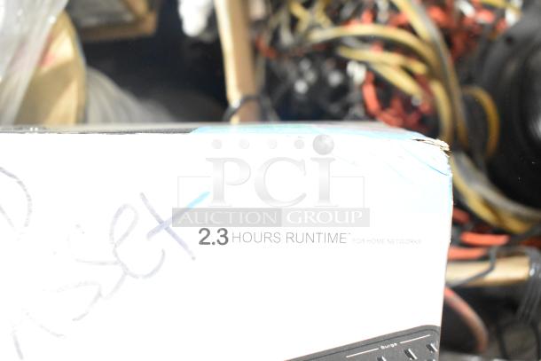 Box showing "2.3 hours runtime for home networks" label, part of auction items including cables and a 26" TFT LCD monitor.