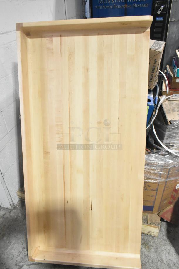 Wooden butcher block tabletop, natural finish, smooth surface, rectangular shape, visible wood grain, in good condition.