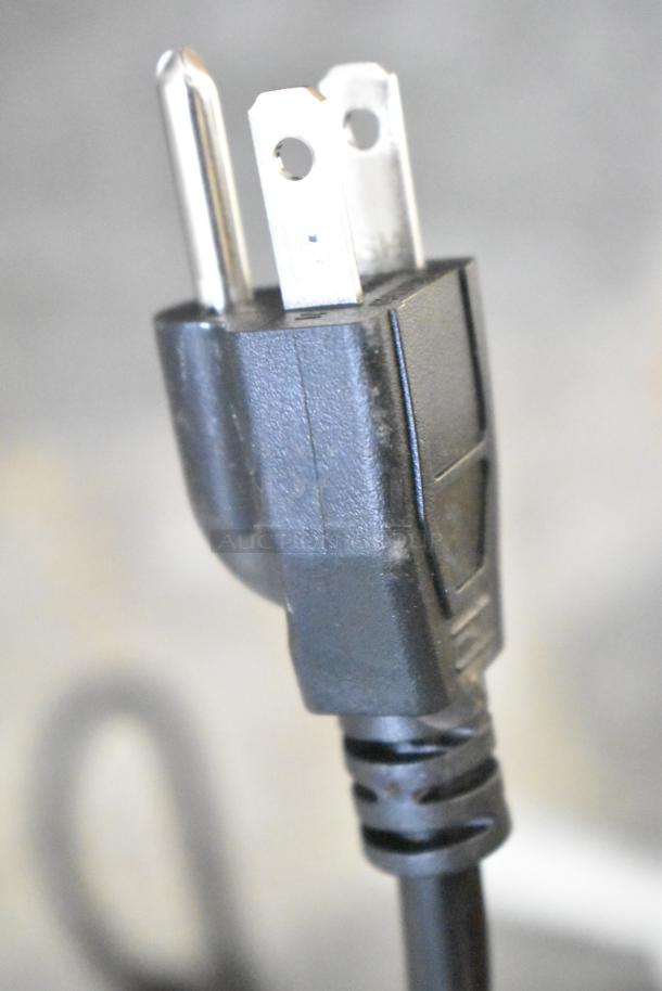 Boltic 6873518LYB Black Metal Air Curtain, 120V, 1 Phase, close-up of power plug in good condition.